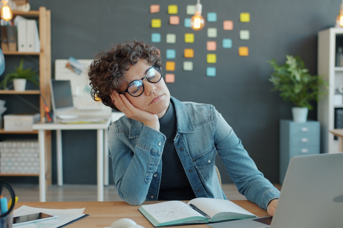 Tired person at desk in the afternoon